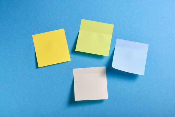 bright colored sticky notes on blue background - Fotó, kép