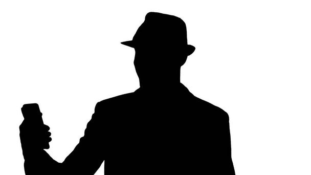Silhouette Attractive man in casual clothes hat hipster stylerecording vlog or making a video call. - Foto, Imagen