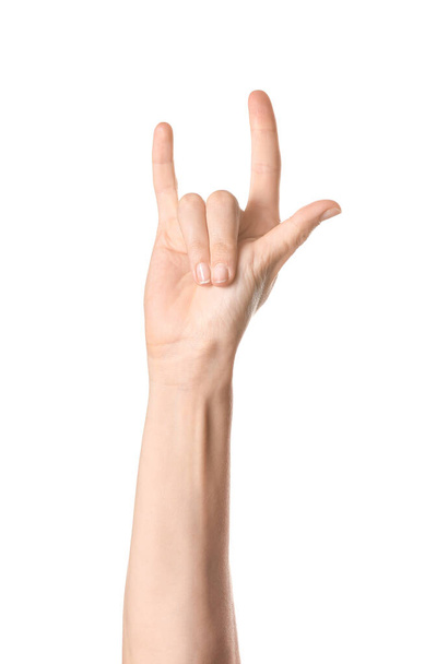Mão de mulher mostrando gesto "chifres do diabo" no fundo branco - Foto, Imagem