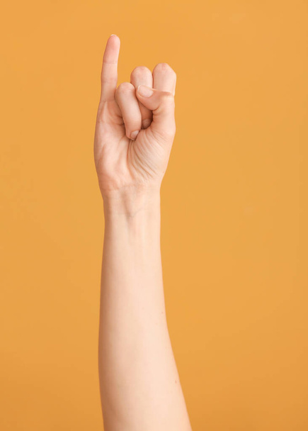 Hand showing letter I on color background. Sign language alphabet - Fotó, kép