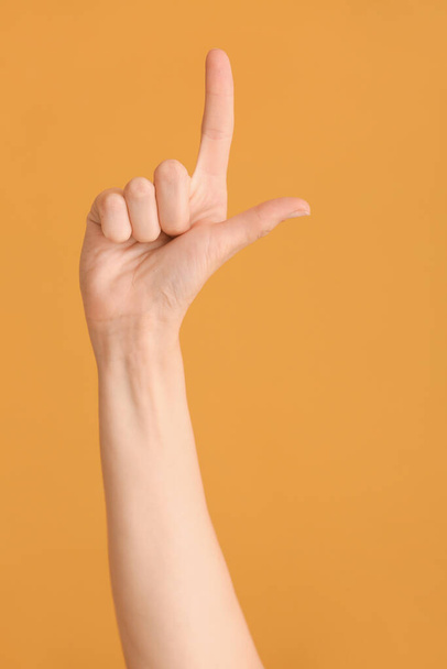 Hand showing letter L on color background. Sign language alphabet - Photo, Image