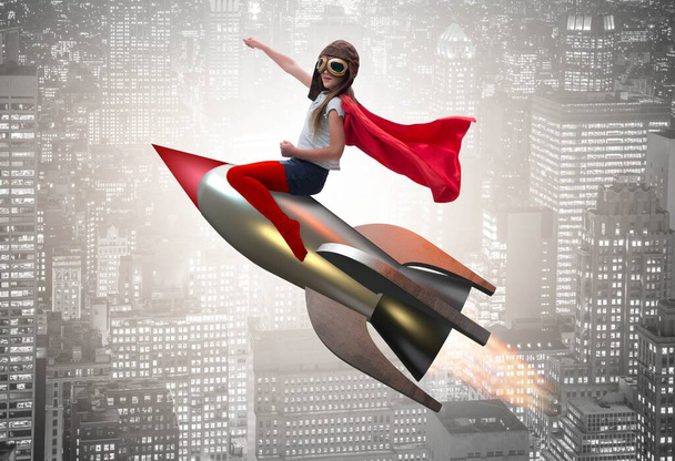 Little girl flying rocket in superhero concept - Photo, Image