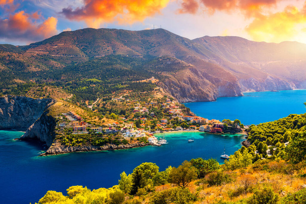Turquoise colored bay in Mediterranean sea with beautiful colorful houses in Assos village in Kefalonia, Greece. Town of Assos with colorful houses on the mediterranean sea, Greece.  - Photo, Image