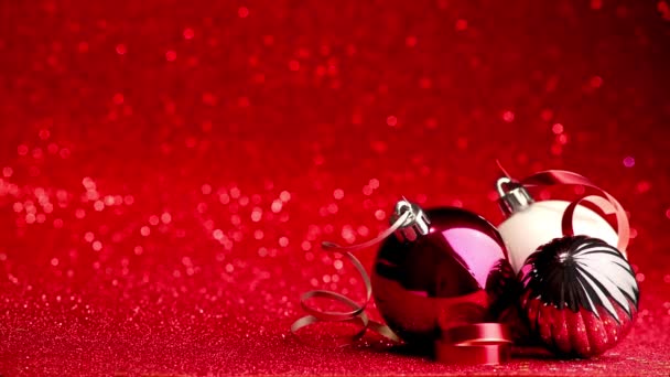 christmas background of balls with ribbons on red glitter background with copy space - Footage, Video