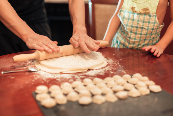 A man rolls out the dough for dumplings - Fotoğraf, Görsel