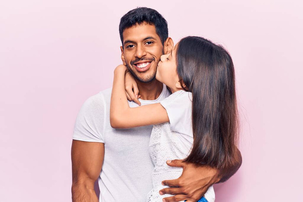 Hispanic young family of father and daughter hugging together with love - Photo, Image