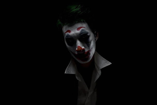 Makeup for Halloween: Image of a man in a joker makeup - Photo, Image