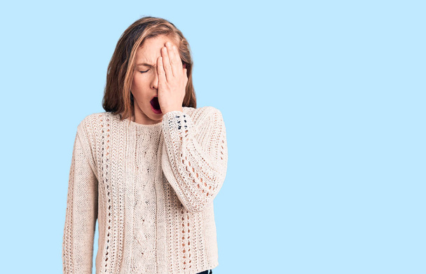 Young beautiful blonde woman wearing casual sweater yawning tired covering half face, eye and mouth with hand. face hurts in pain.  - Photo, Image