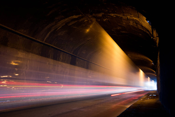 光のカラフルな歩道と古い暗いトンネル. - 写真・画像