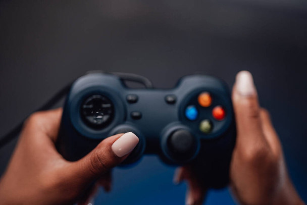 Pretty hands of afro girl holds small joystick in background - Фото, изображение