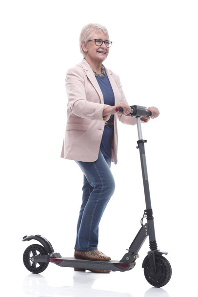 in full growth. happy adult woman with electric scooter. - Фото, зображення
