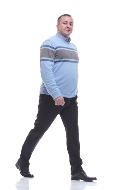side view. a serious man in a sweater walks forward - Foto, Imagen