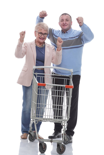 in full growth. cute couple with shopping cart. - Φωτογραφία, εικόνα
