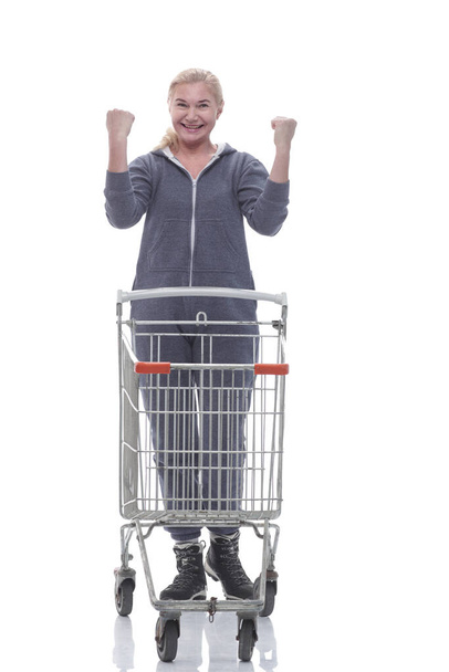 in full growth. smiling woman in casual clothes with shopping cart - Photo, Image