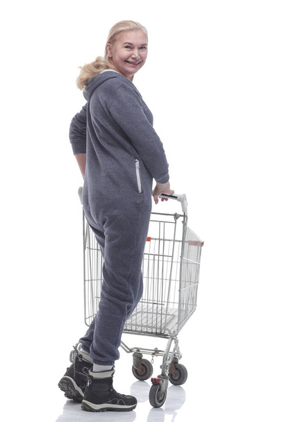 rear view. smiling woman with shopping cart looking at you - Foto, Imagem