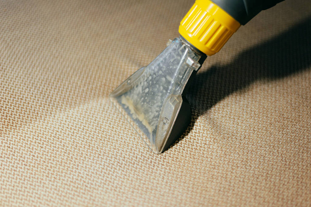 Close up photo of cleaning furniture with vaccum cleaner, before and after effect - Photo, Image