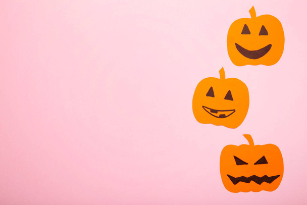 Halloween decorations with paper pumpkins on pink background. Top view - Photo, Image
