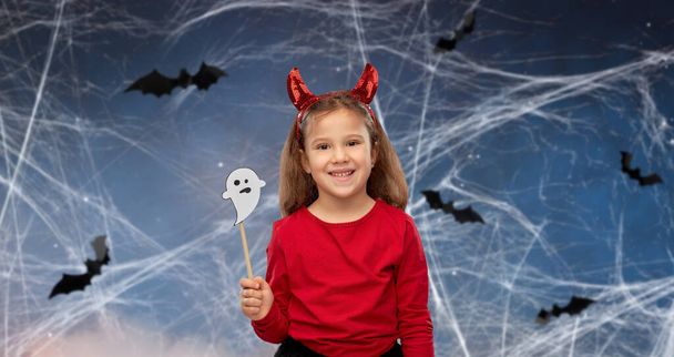 girl in halloween costume with ghost party prop - Fotó, kép