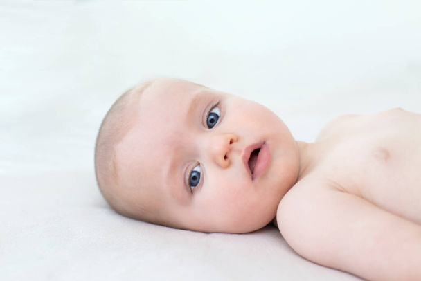 Cute adorable baby girl lying on the bed - Photo, Image