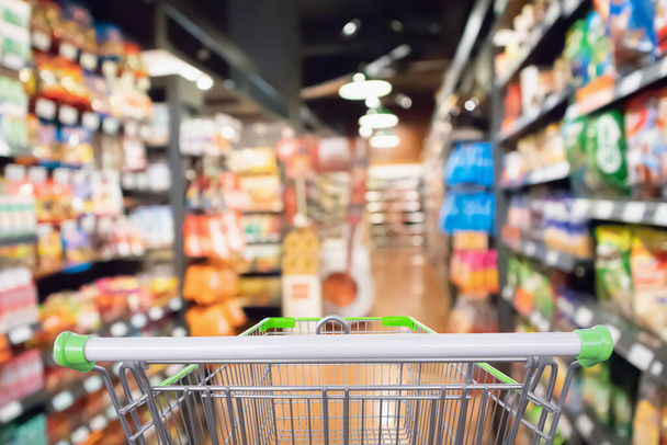 Фон прохода супермаркета и полки продуктов с пустой корзиной - Фото, изображение