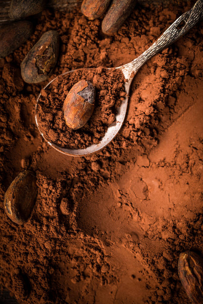 Organiczny proszek kakaowy z ziarnem kakaowym do pieczenia. Składniki pieczenia i gotowania. - Zdjęcie, obraz
