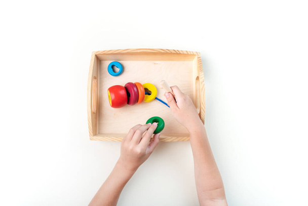 Montessori material. Hand of a child. White background. Toddler education. Study of mathematic and letter. School and kindergarten. - Foto, Imagem