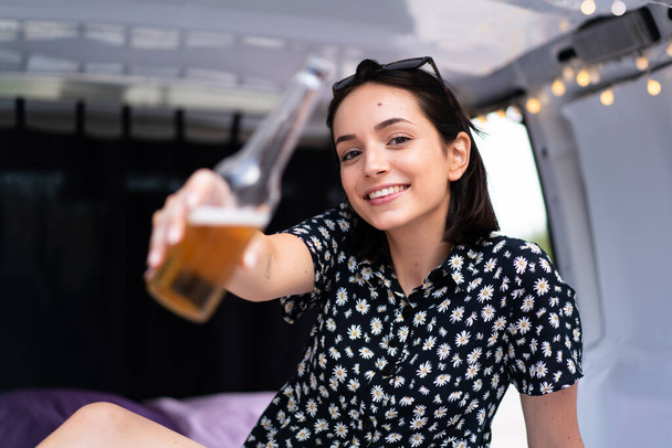Young caucasian woman in a camper van at outdoors - Photo, Image