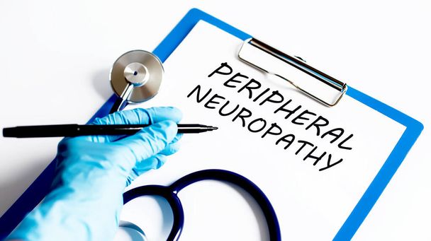 Paper with text PERIPHERAL NEUROPATHY on a table with stethoscope. Medical concept - Photo, Image