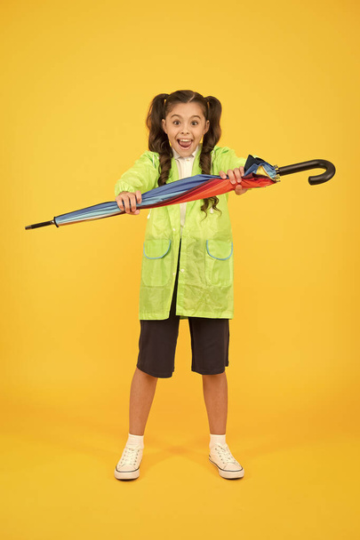 Waterproof concept. Match your raincoat with umbrella. Schoolgirl wear raincoat. Small schoolgirl wear water resistant clothes for rainy day. Cute schoolgirl feel protected for spring weather - Photo, image