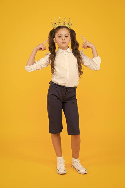 Look who is a big boss here. Little big boss on yellow background. Cute girl boss wearing crown. Small child with big ambitions. Adorable boss lady being serious for dreaming big - Foto, Imagen