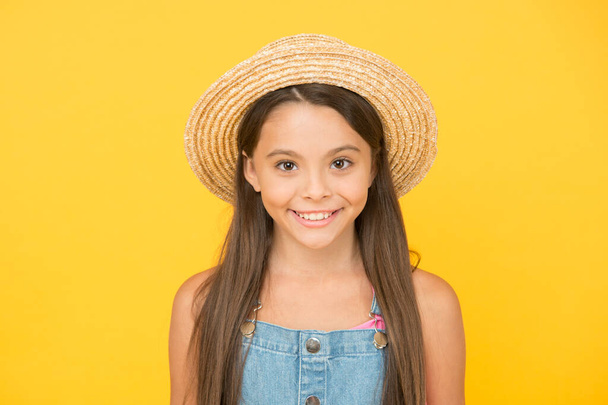 Summer holidays. Fashionably dressed girl. Enjoying vacation. Fancy outfit. Summer fashion. Good vibes. Beach style. Beauty in hat. Portrait of happy cheerful girl in summer hat yellow background - Foto, imagen
