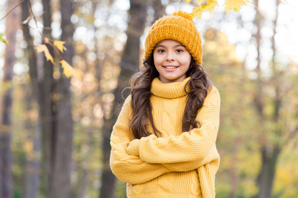 pretty kid wear yellow knitted sweater and hat, autumn - Fotó, kép