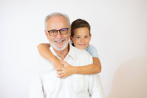 Senior man with glasses hugs his grandchild - Foto, imagen