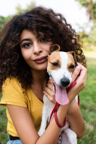 Selective focus of young woman with jack russell terrier dog looking at camera - Photo, Image