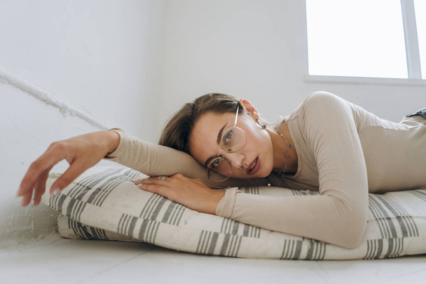 Closeup of young woman lying on mattress - Fotografie, Obrázek
