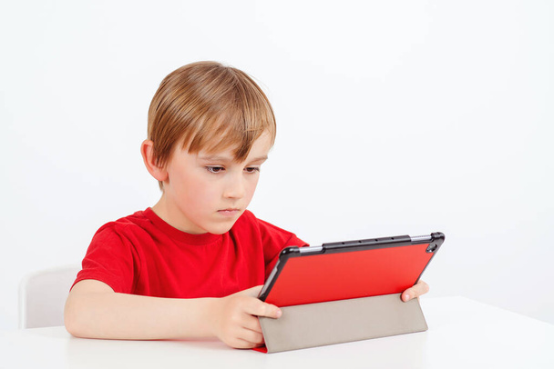 Online education and e-learning concept. School boy using gadget during online lesson. Online education during quarantine. Home schooling concept. Coronavirus pandemic. Remote education. - Photo, image