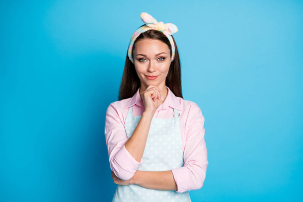 Photo of attractive pretty lady long hairdo house wife arm on chin think what cook for dinner good mood wear headband dotted apron pink shirt isolated blue color background - Valokuva, kuva