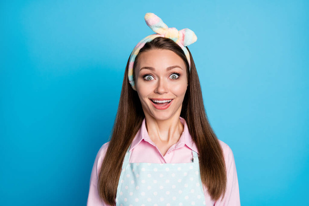Closeup photo of attractive shocked lady listen nice news open mouth overjoyed facial expression wear headband dotted apron pink shirt isolated blue color background - Foto, immagini