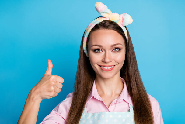 Portrait of positive cheerful girl show thumb up sign recommend choose decide ads promotion decision, choice wear good look clothes isolated over blue color background - 写真・画像