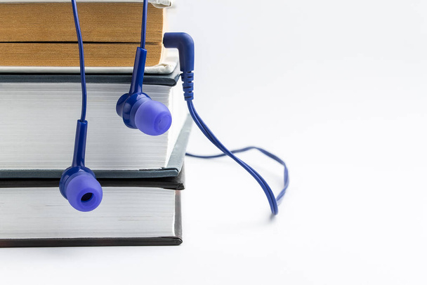 Books and headphones on white bacground. Audiobook concept - Zdjęcie, obraz