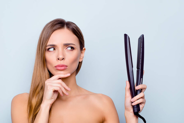 Close up photo portrait of cute pretty attractive brunette she her lady holding curl iron in hand can not decide use it or not isolated on grey background - Photo, Image