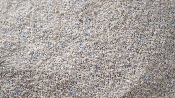 Absorbent gray white cat litter. Rotation Close-up. Lumpy flavored pet litter concept - 映像、動画