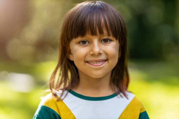 Portrait of cute little girl smiling outdoors - Фото, зображення