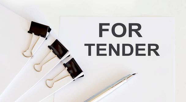 FOR TENDER written on a white page with office tools - Photo, Image