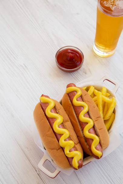 Homemade Mustard Hot Dog with French Fries on a white wooden background, high angle view. Copy space. - Photo, Image