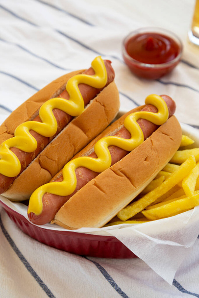 Homemade Mustard Hot Dog with French Fries, side view.  - 写真・画像