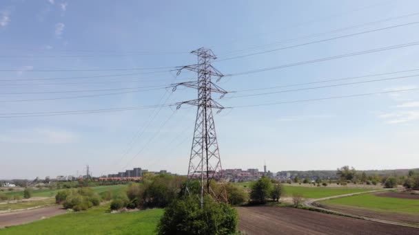 Power pylons and high voltage lines in an agricultural landscape. High-voltage masts. Electricity transmission power lines.4K, UHD, Cinematic, Aerial footage - Footage, Video