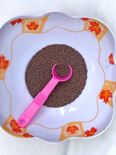 Mustard seeds in a bowl with spoon - Photo, Image
