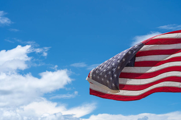 Waving USA flag under blue sky background. - Foto, Imagen