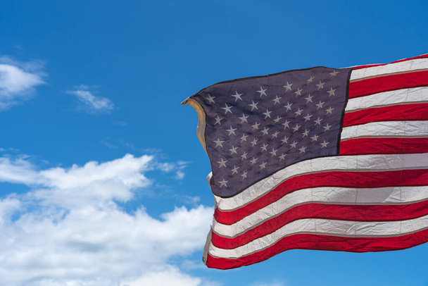 Waving USA flag under blue sky background. - Foto, Imagem
